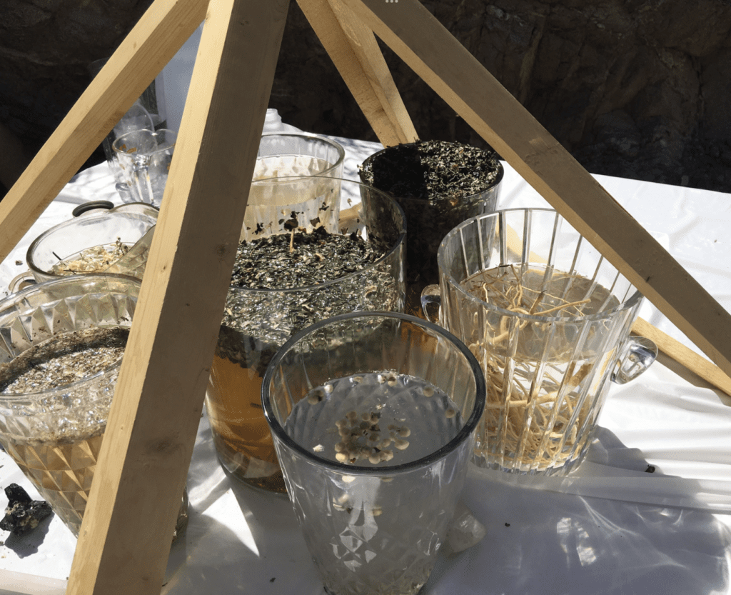 A table with cups and bowls of food on it.